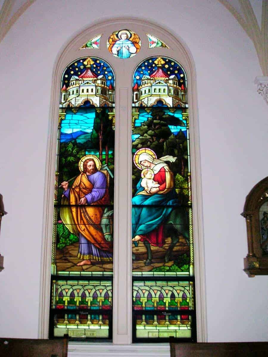 Stained glass window of Jesus, Mary, and Joseph fleeing into Egypt in the Chapel of the Incarnate Word.